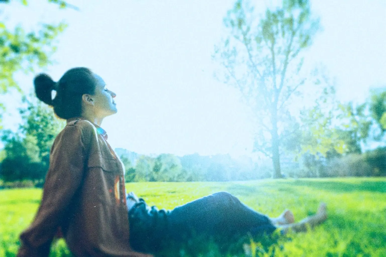 woman relaxing on the grass at a park