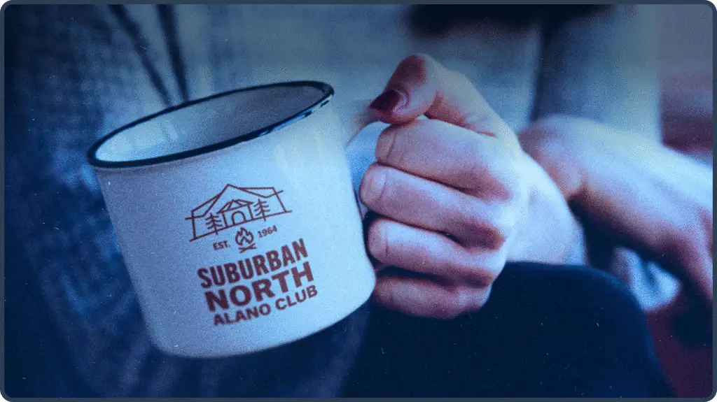 Alcoholics Anonymous Alano Club Coffee cup with logo held by a female hand