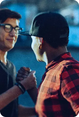 two young men giving a handshake